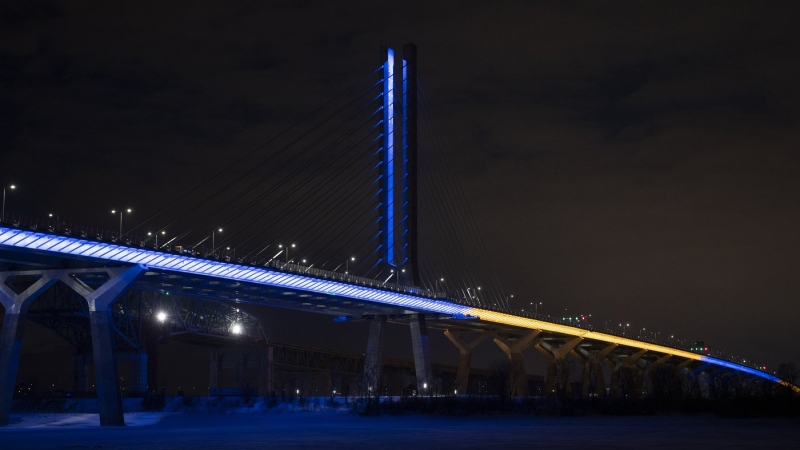 The Samuel de Champlain Bridge is shown lit up in the colours of Ukraine in Montreal, Saturday, Feb. 26, 2022, in a show of support from the government of Canada for the Ukrainian people and all Ukrainian Canadians. (Graham Hughes, The Canadian Press)