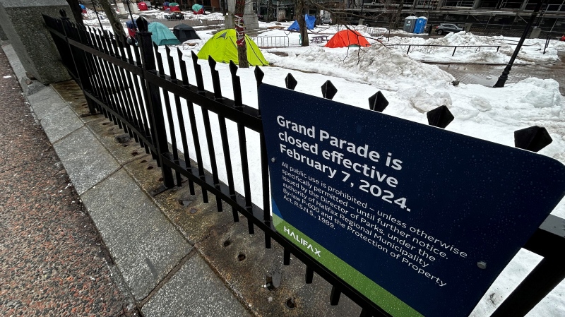 A sign is posted about the closure of the Grand Parade encampment. (CTV/Jonathan MacInnis)