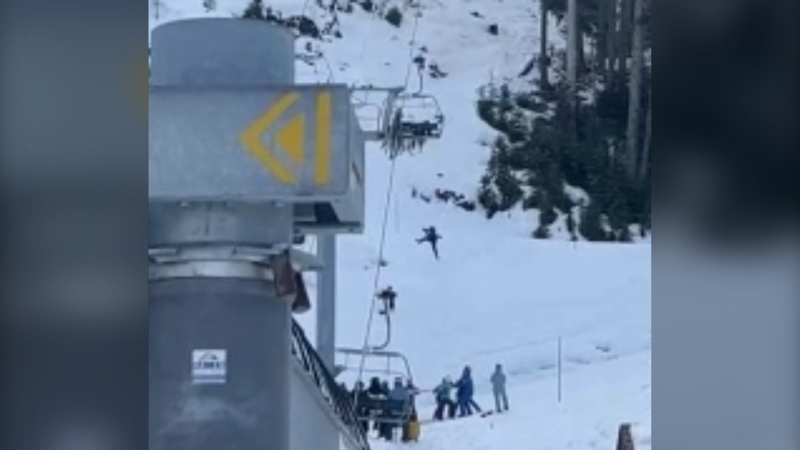 This screen grab from a video posted to social media shows someone at Whistler falling from a chairlift, where a crew waits to catch them on the ground. (Image credit: Facebook/Richard Green)