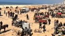 Palestinians wait for humanitarian aid on a beachfront in Gaza City, Gaza Strip, Sunday, Feb. 25, 2024. (Mahmoud Essa / AP Photo)