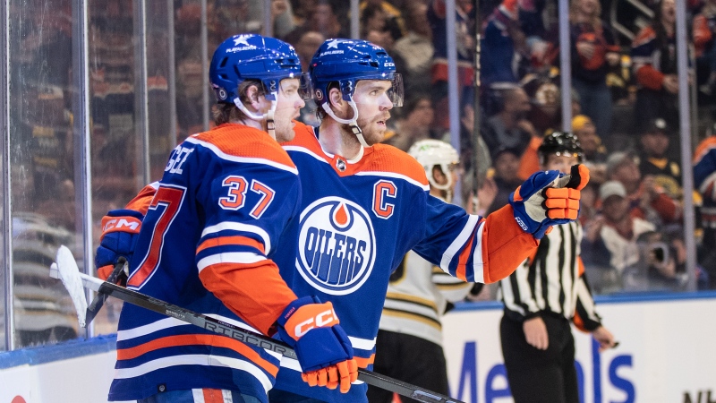 Edmonton Oilers' Warren Foegele (37) and Connor McDavid (97) celebrate a goal against the Boston Bruins' during second period NHL action in Edmonton on Wednesday February 21, 2024.THE CANADIAN PRESS/Jason Franson