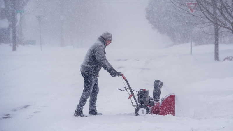 A person pushes a snowblower in Saskatoon, Sask., Monday, Feb. 26, 2024. (Heywood Yu / THE CANADIAN PRESS)