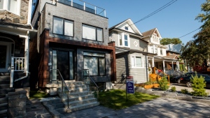 A Sold sign sits in front of a house in Toronto on Tuesday July 12, 2022. THE CANADIAN PRESS/Cole Burston