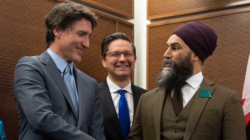 Prime Minister Justin Trudeau shakes hands with New Democratic Party leader Jagmeet Singh as Conservative leader Pierre Poilievre looks on at a Tamil heritage month reception, Monday, January 30, 2023 in Ottawa. THE CANADIAN PRESS/Adrian Wyld