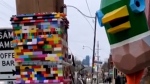 A mundane street pole in Toronto is getting attention as a community of artists builds a tower of LEGO – five feet and counting – around it. (Supplied/Martin Reis)

