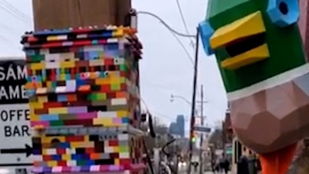 A mundane street pole in Toronto is getting attention as a community of artists builds a tower of LEGO – five feet and counting – around it. (Supplied/Martin Reis)

