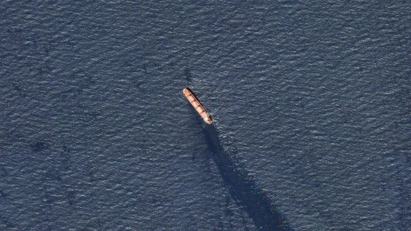 In this satellite image provided by Planet Labs, the Belize-flagged bulk carrier Rubymar is seen in the southern Red Sea near the Bay el-Mandeb Strait leaking oil after an attack by Yemen's Houthi rebels, Feb. 20, 2024. (Planet Labs PBC via AP)
