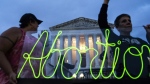 Activists display neon signage in support of abortion access in front of the U.S. Supreme Court on June 23, 2023, in Washington. (AP Photo/Nathan Howard, File)