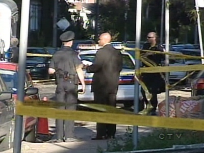 Police investigate the shooting scene on Simpson Avenue, near Broadview Avenue and Dundas Street on Sunday, Oct. 21, 2007.