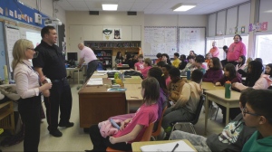 Waterloo Regional Police Service officer speaks to students about bullying during Pink Shirt Day on Deb. 28, 2024. (David Pettitt / CTV News)