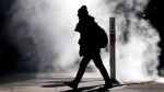 A man walks through steam in the cold winter weather in Toronto, on Friday, Feb. 3, 2023. THE CANADIAN PRESS/Nathan Denette