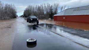 A truck drives through a flooded road in Sussex, N.B., on Feb. 29, 2024. (Derek Haggett/CTV Atlantic)