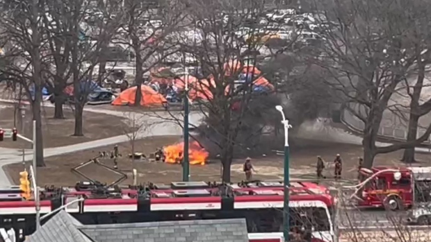Toronto firefighters work to douse a tent fire at Clarence Square on Feb. 29.