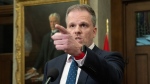 Minister of Health Mark Holland gestures to a reporter as he takes questions in the Foyer of the House of Commons on Wednesday, February 28, 2024 in Ottawa. THE CANADIAN PRESS/Adrian Wyld 