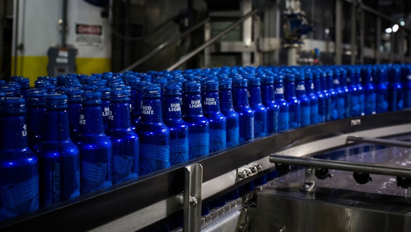 Bottles of Bud Light beer move along a conveyor at an Anheuser-Busch InBev facility in St. Louis, Missouri, United States, in July 2018. (Alex Flynn / Bloomberg / Getty Images via CNN Newsource)