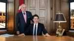 Prime Minister Justin Trudeau, right, sits behind the desk of former prime minister Brian Mulroney, left, while touring a replica of Mr. Mulroney's former parliamentary office in Mulroney Hall at St. Francis Xavier University in Antigonish, N.S. on Monday, June 19, 2023. (Darren Calabrese/THE CANADIAN PRESS)