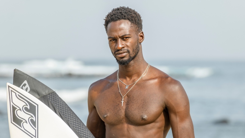 Cherif Fall, Senegal's number one surfer paddles to the wave in the Atlantic Ocean in Dakar, Senegal, Wednesday, Feb. 28, 2024. (AP Photo/Sylvain Cherkaoui)