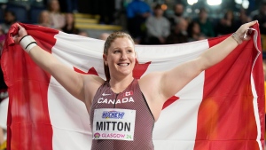 Canada's Sarah Mitton poses after winning the gold medal in the women's shot put during the World Athletics Indoor Championships at the Emirates Arena in Glasgow, Scotland, Friday, March 1, 2024. (AP Photo/Bernat Armangue)