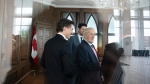 Prime Minister Justin Trudeau, Sean Fraser, and former prime minister Brian Mulroney are seen through glass at St. Francis Xavier University in Antigonish, N.S. on Monday, June 19, 2023. THE CANADIAN PRESS/Darren Calabrese