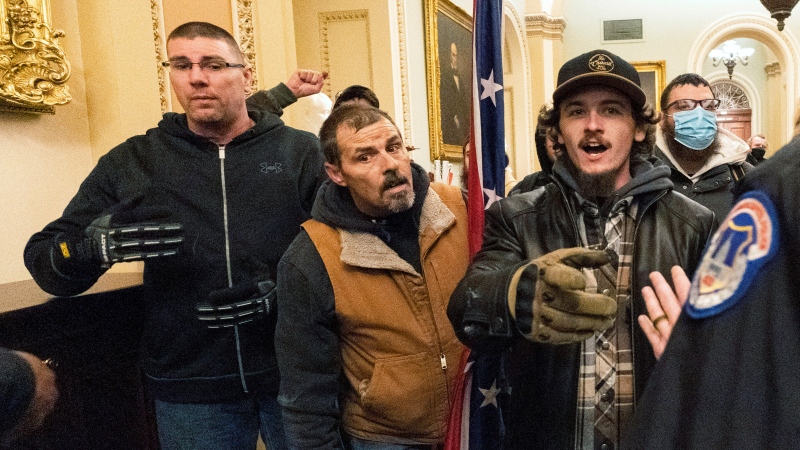 Michael Sparks, left, and Kevin Seefried, second from left, are confronted by U.S. Capitol Police officers outside the Senate Chamber inside the Capitol in Washington, Jan. 6, 2021. (AP Photo/Manuel Balce Ceneta, File)