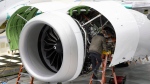 A Boeing employee works on the engine of a 737 MAX on the final assembly line at Boeing's Renton plant. The Federal Aviation Administration has flagged more safety issues for two troubled families of Boeing planes. (Ellen M. Banner / Pool / The Seattle Times/AP)