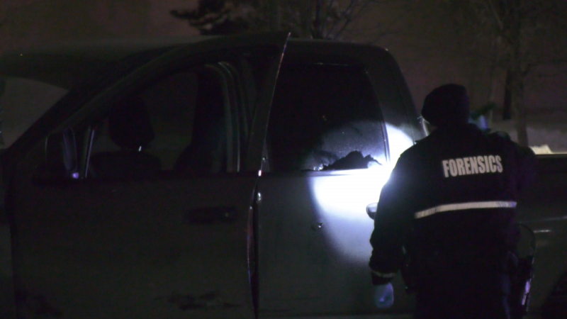 An officer examines damage to a truck used by a suspect, wanted for a stabbing, who was shot by police in west Edmonton March 1, 2024. (Sean McClune/CTV News Edmonton)