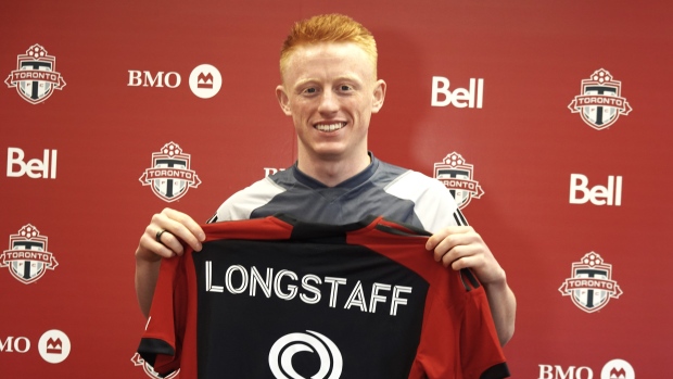 Newly-signed Toronto FC midfielder Matty Longstaff holds up his jersey after training in Toronto on Friday, March 1, 2024.THE CANADIAN PRESS/Neil Davidson