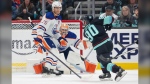 Seattle Kraken left wing Tomas Tatar (90) shots the puck as Edmonton Oilers goaltender Stuart Skinner (74) and defenseman Darnell Nurse (25) defend during the second period of an NHL hockey game Saturday, March 2, 2024, in Seattle. (AP Photo/Jason Redmond)