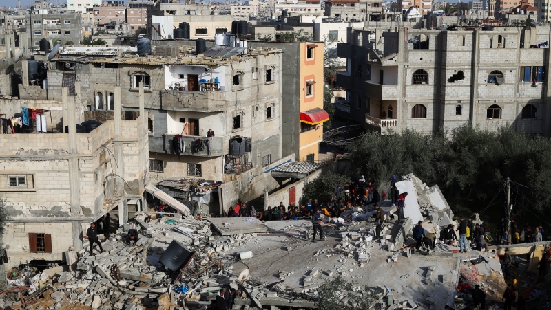 Palestinians look at the destruction after an Israeli strike on a residential building in Rafah, Gaza Strip, Sunday, March 3, 2024. (AP Photo/Hatem Ali)