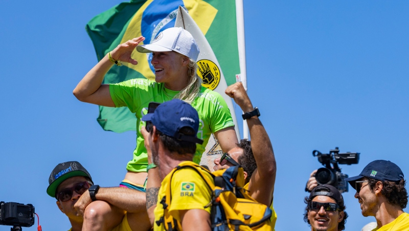 Tatiana Weston Webb of Brazil, top, celebrates winning the silver medal at the final of the ISA World Surfing Games, a qualifier for the Paris 2024 Olympic Games, at La Marginal beach in Arecibo, Puerto Rico, Sunday, March. 3, 2024. (AP Photo/Alejandro Granadillo)