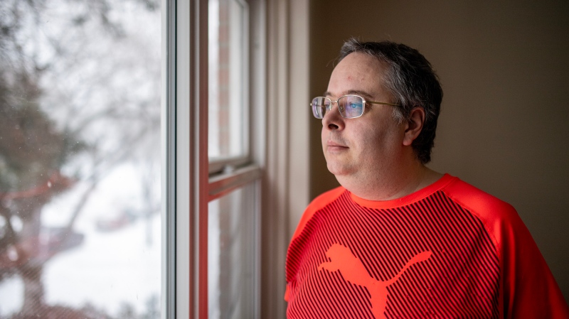 Alan Holman, who's on low income and relies on the carbon rebate to make ends meet, stands for a photograph in his apartment in Saskatoon. (Liam Richards / Canadian Press)