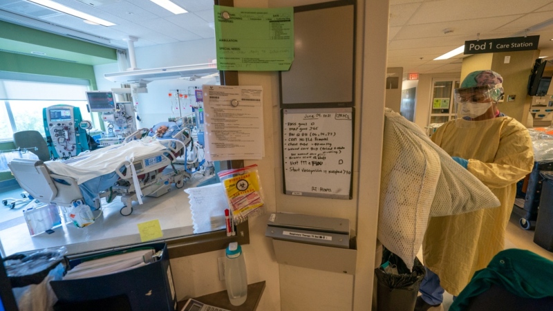 A nurse prepares to see a patient at Surrey Memorial Hospital in Surrey, B.C., on June 4, 2021. (Jonathan Hayward / The Canadian Press)