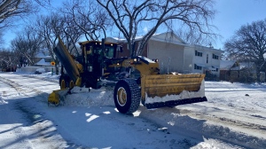 A City of Regina grader clears snow from 15th Ave on March 4, 2024. (Gareth Dillistone/CTV News)