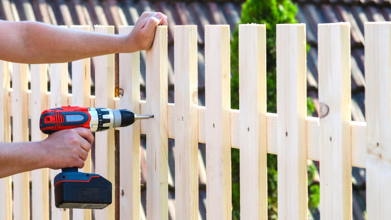 This photo shows a person building a fence. (Image credit: Shutterstock) 