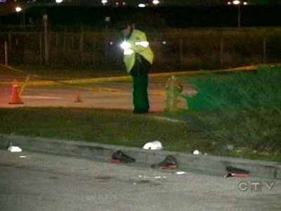 Investigators inspect the parking lot on Carlingview Drive where the victim was struck at around 2:30 a.m.
