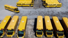 In this photo taken using a drone, school buses are seen in a lot in Ottawa on Monday, April 18, 2022. (Sean Kilpatrick/The Canadian Press)