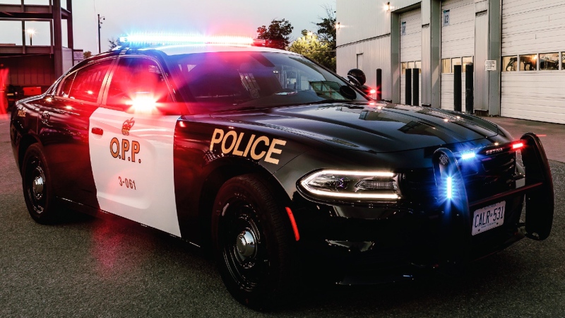 An Ontario Provincial Police vehicle parked red and blue lights flashing. (File photo/Supplied/Ontario Provincial Police)