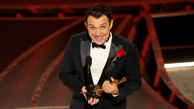 Ben Proudfoot accepts the award for best documentary short subject for "The Queen of Basketball" at the Oscars on Sunday, March 27, 2022, at the Dolby Theatre in Los Angeles. (AP Photo/Chris Pizzello)