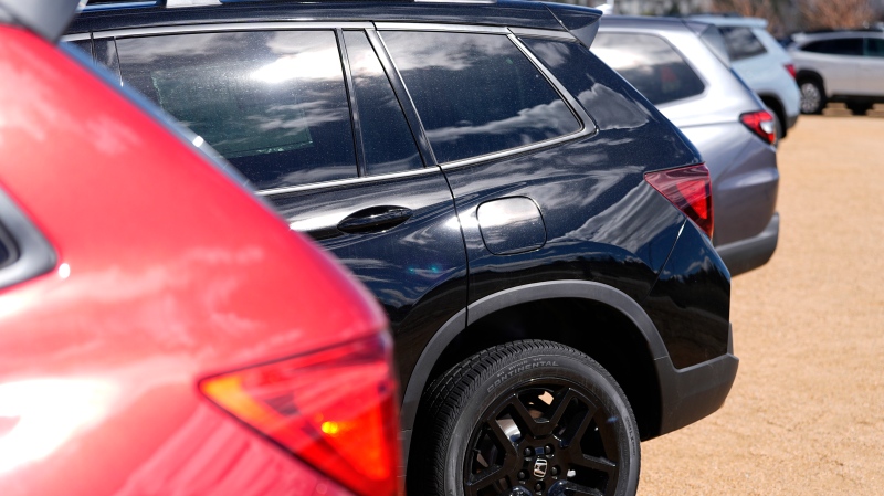Unsold 2024 Passport and Pilot sports-utility vehicles sit on display at a Honda dealership Sunday, March 3, 2024, in Highlands Ranch, Colo. (AP Photo/David Zalubowski)