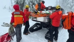 A B.C. snowshoer is loaded onto a North Shore rescue vehicle on a sled after being rescued from an avalanche on Mount Seymour. (North Shore Rescue/Facebook)