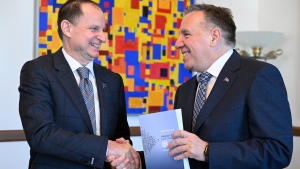Quebec Finance Minister Eric Girard shakes hand with Quebec Premier Francois Legault after giving him a copy of his provincial budget, Tuesday, March 12, 2024 at the premier’s office in Quebec City. (Jacques Boissinot / The Canadian Press)