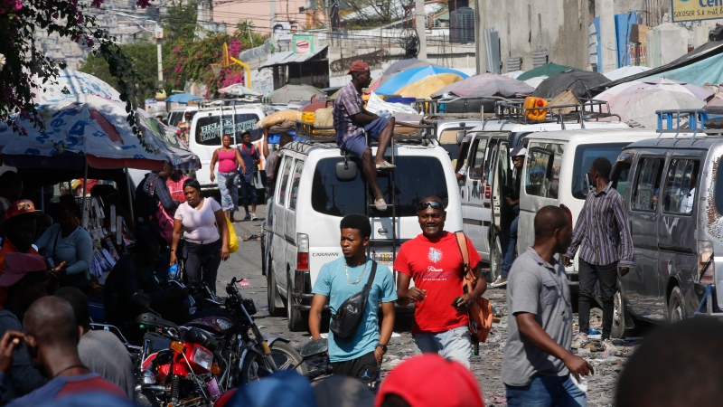 Pedestrians and commuters fill a street in Port-au-Prince, Haiti, Tuesday, March 12, 2024. (AP Photo / Odelyn Joseph)