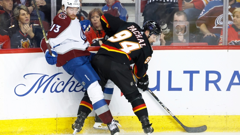 Colorado Avalanche's Valeri Nichushkin, left, is knocked off the puck by Calgary Flames' Brayden Pachal during first period NHL hockey action in Calgary, Tuesday, March 12, 2024. THE CANADIAN PRESS/Larry MacDougal