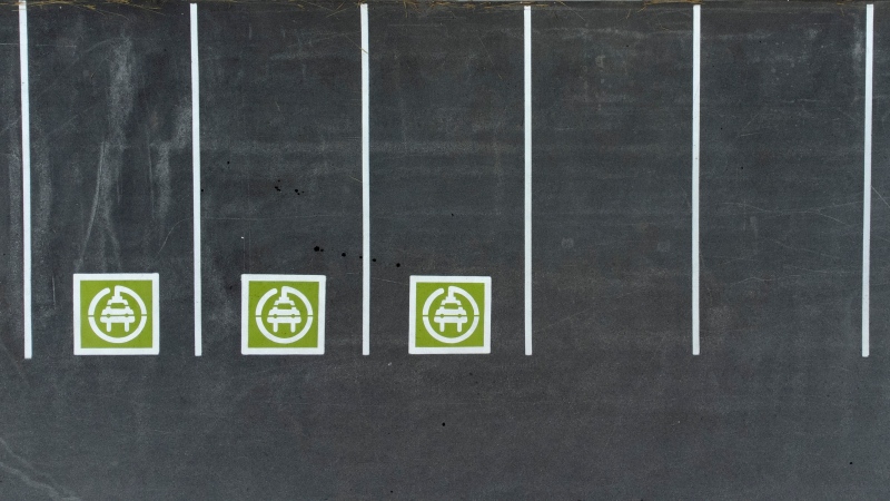 Parking spots designated for electric vehicles are seen outside a store in Ottawa, Monday, July 17, 2023. THE CANADIAN PRESS/Adrian Wyld