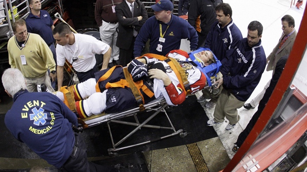 Florida Panthers forward David Booth is wheeled off the ice after being injured in the second period of an NHL hockey game against the Philadelphia Flyers, Saturday, Oct. 24, 2009. Booth suffered a concussion after a blindside head shot. (AP / Matt Slocum)