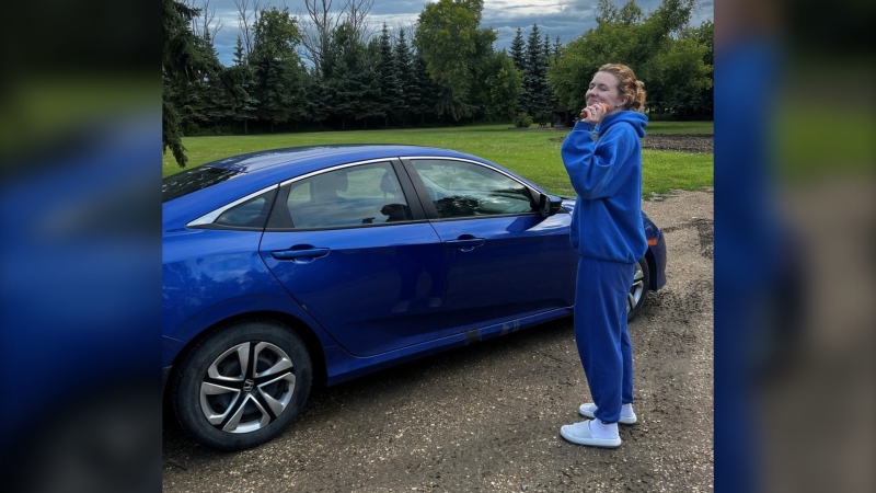 Alana Schlichting poses with her car in an undated image. Schlichting had her vehicle stolen in November, recovered, and then stolen again in February from a repair shop it was being serviced at. (Submitted photo)