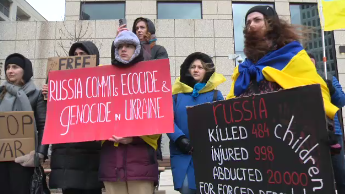 Dozens of Ukrainian demonstrators held signs protesting Russian captivity at a rally near Portage and Main on March 16, 2024. (Daniel Timmerman/CTV News)