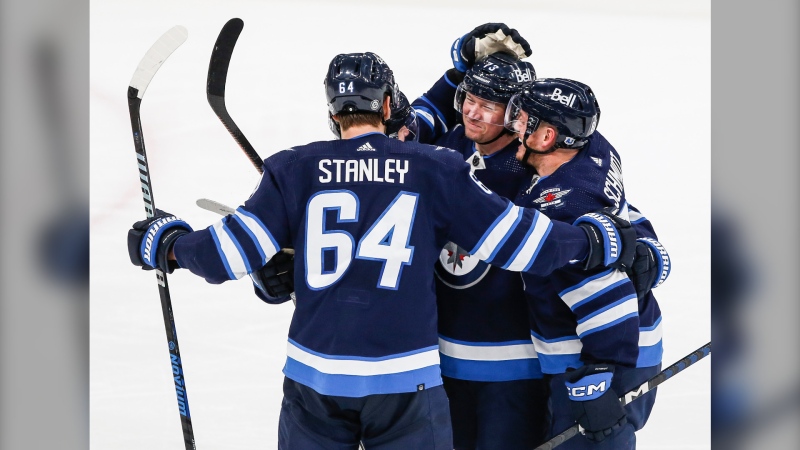Winnipeg Jets' Logan Stanley (64), Nikolaj Ehlers (27), Tyler Toffoli (73) and Nate Schmidt (88) celebrate Toffoli’s first goal against the Anaheim Ducks' during third period NHL action in Winnipeg, Friday, March 15, 2024. THE CANADIAN PRESS/John Woods 