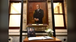 A photograph and book of condolences are seen in front of the official portrait of former prime minister Brian Mulroney, in the antechamber to the House of Commons on Parliament Hill in Ottawa, Friday, March 1, 2024. THE CANADIAN PRESS/Justin Tang