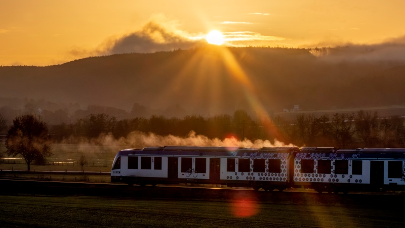 A hydrogen train approaches the station of Wehrheim near Frankfurt, Germany, as the sun rises on Tuesday, Dec. 12, 2023. (AP Photo/Michael Probst)